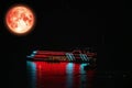 Christmas moon, Cold moon back over night sky and restaurant ship on sea Royalty Free Stock Photo