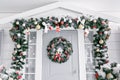 Christmas morning. house entrance decorated for holidays. Christmas decoration. garland of fir tree branches and lights Royalty Free Stock Photo