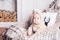 Christmas morning. Little girl in jumpsuit deer sitting in a toboggan. Royalty Free Stock Photo