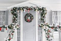 Christmas morning. porch a small house with a decorated door with a Christmas wreath. Winter fairy tale. Royalty Free Stock Photo