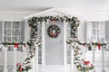 Christmas morning. porch a small house with a decorated door with a Christmas wreath. Winter fairy tale. Royalty Free Stock Photo