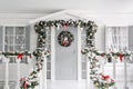 Christmas morning. porch a small house with a decorated door with a Christmas wreath. Winter fairy tale.