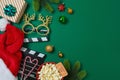 Christmas movie night and party concept with popcorn, Santa hat, decorations and movie clapper board on green background. Top Royalty Free Stock Photo