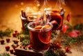 Christmas mulled red wine with aromatic spices and citrus fruits on a wooden rustic table, close-up. Royalty Free Stock Photo