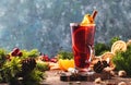 Christmas mulled red wine with spices and fruits in tall glass on wooden rustic table. Traditional Christmas or NewYear warming Royalty Free Stock Photo