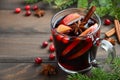 Christmas Mulled Wine with Apple and Cranberries. Holiday Concept Decorated with Fir Branches, Cranberries and Spices. Royalty Free Stock Photo