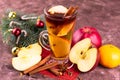 Christmas mulled wine with apples and citrus fruits and spices in a tall glass. Royalty Free Stock Photo