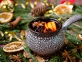 Christmas mulled wine with cinnamon, orange and star anise in a ceramic bowl with winter decorations