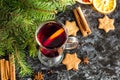 Christmas mulled wine with ginger biscuits orange cinnamon clove anise and fir tree on the dark table Royalty Free Stock Photo