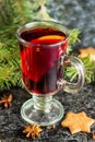 Christmas mulled wine with ginger biscuits orange cinnamon clove anise and fir tree on the dark table Royalty Free Stock Photo