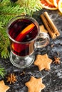 Christmas mulled wine with ginger biscuits orange cinnamon clove anise and fir tree on the dark table Royalty Free Stock Photo