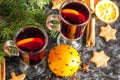 Christmas mulled wine with ginger biscuits orange cinnamon clove anise and fir tree on the dark table Royalty Free Stock Photo