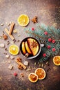 Christmas mulled wine or gluhwein with spices and orange slices on rustic table top view. Traditional drink on winter holiday. Royalty Free Stock Photo