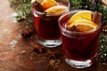 Christmas mulled wine or gluhwein with spices and orange slices on rustic table, traditional drink on winter holiday, magic light Royalty Free Stock Photo