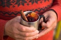 Christmas mulled wine in Hand of old man, delicious holiday like parties with orange cinnamon star anise spices. Traditional hot Royalty Free Stock Photo