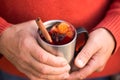 Christmas mulled wine in Hand of old man, delicious holiday like parties with orange cinnamon star anise spices. Traditional hot Royalty Free Stock Photo