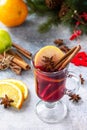 Christmas mulled wine, winter alcoholic drink. A glass of mulled wine gluhwein and its ingredients on a stone background. Royalty Free Stock Photo