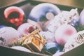 Christmas multicolored toys, textured balls lie in an open box, effect of the instagram Royalty Free Stock Photo