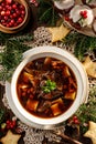Christmas mushroom soup, a traditional vegetarian mushroom soup made with dried forest mushrooms in a ceramik plate on a festive