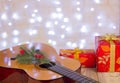 Christmas music background.Guitar and red gifts Royalty Free Stock Photo