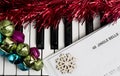 Christmas music concept. Printed music on the piano with jingle bells, snowflake and spangle