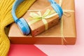 Christmas music gift concept. Headphones and gift boxes on colorful background. Royalty Free Stock Photo