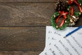 Christmas music note paper with Christmas wreath on wo