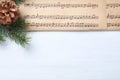 Christmas music sheets and fir tree branch and space for text on white wooden background, top view Royalty Free Stock Photo