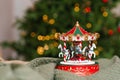 Christmas musical toy carousel on the background of the burning lights of the Christmas tree Royalty Free Stock Photo