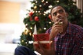 Christmas is my favourite time of year. a handsome young man thinking of something to write in a christmas card. Royalty Free Stock Photo