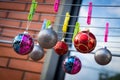 Christmas Balls Ornaments hanging on the clips on the  Clothes Drying Rack. Royalty Free Stock Photo