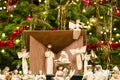 Christmas nativity scene with blurred Chrstmas tree in background