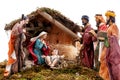 Christmas nativity scene with Holy Family in the hut and the three wise men, on white background Royalty Free Stock Photo