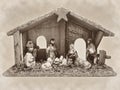 Christmas nativity scene manger with figurines including Jesus, Mary, Joseph, sheep and magi sepia Royalty Free Stock Photo