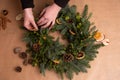 Christmas natural wreath. Florist s hands making natural Christmas wreath, christmas decorations with natural fir branches