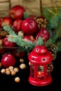 Christmas and New year. Apples with pine cones and nuts in a basket with fir branches. Gifts and candles. Royalty Free Stock Photo