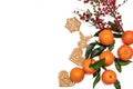 Christmas and new year atmoshpere flatlay. Overhead view. Gingerbread cookies, tangerines and branch with red berries isolated on