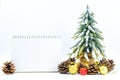 Christmas or New Year background with blank note pad,pine cones,gift box,golden ball and pine tree of Xmas decorations and fir br Royalty Free Stock Photo