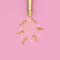 Christmas and New Year background. Champagne bottle, festive golden ribbons and star confetti on pink background top view. Flat Royalty Free Stock Photo