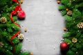 Christmas and New Year background. Christmas tree branch on a black background. Cones and fur-tree toys. View from above. Royalty Free Stock Photo