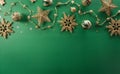 Christmas and new year background concept. Top view of Christmas ball, star and golden snowflake on green background