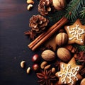 Christmas or New Year background with cookies, spices, cinnamon, nuts and fir tree branch on dark wooden background Royalty Free Stock Photo