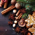 Christmas or New Year background with cookies, spices, cinnamon, nuts and fir tree branch on dark wooden background Royalty Free Stock Photo