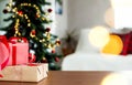 Christmas, New Year background. Empty wooden tabletop with bokeh fir tree, gift Royalty Free Stock Photo