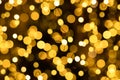 Christmas and New year background from defocused blurry golden blinker lights