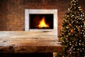 Christmas and New year background with empty dark wooden deck table over christmas tree and blurred light bokeh. Royalty Free Stock Photo