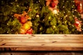 Christmas and New year background with empty dark wooden deck table over christmas tree and blurred light bokeh. Royalty Free Stock Photo