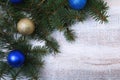 Christmas or New Year background: fur-tree, branches, colored glass balls , decoration and cones on a wooden background Royalty Free Stock Photo