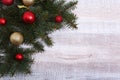 Christmas or New Year background: fur-tree, branches, colored glass balls , decoration and cones on a wooden background Royalty Free Stock Photo