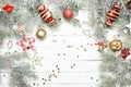 Christmas or New Year background: fur-tree branches, colorful glass balls, decoration and glittering stars on white wood Royalty Free Stock Photo